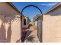 Pathway leading to the backyard through an arched gate at 7318 W Greer Ave, Peoria, AZ 85345