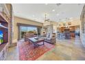Spacious living area with stone fireplace and kitchen view at 10843 E La Junta Rd, Scottsdale, AZ 85255