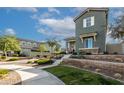 Two-story craftsman style home with stone accents and landscaped yard at 21065 W Elm Way Ct, Buckeye, AZ 85396