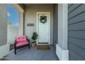 Inviting front entry with modern door and charming decor at 21065 W Elm Way Ct, Buckeye, AZ 85396