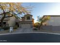 Two-story house with tan exterior, two-car garage, and landscaped yard at 333 E Redwood Ln, Phoenix, AZ 85048