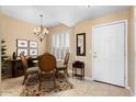 Bright dining area with a four-person table and chandelier at 14950 W Mountain View Blvd # 4308, Surprise, AZ 85374