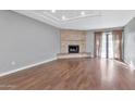 Living room features hardwood floors, stone fireplace, and access to patio at 16616 E Palisades Blvd # 102, Fountain Hills, AZ 85268