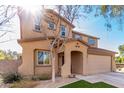 Two-story house with artificial turf, driveway, and attached garage at 17395 W Straight Arrow Ln, Surprise, AZ 85387