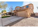 Two-story house with gravel driveway and attached garage at 17395 W Straight Arrow Ln, Surprise, AZ 85387