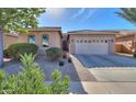 One-story home with neutral exterior, two-car garage, and well-manicured front yard at 2627 E San Simeon Dr, Casa Grande, AZ 85194