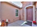 Inviting entryway with a purple door and stone accents at 2627 E San Simeon Dr, Casa Grande, AZ 85194