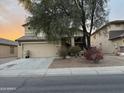 Two-story house with beige exterior, attached garage, and landscaping at 4112 S 249Th Dr, Buckeye, AZ 85326