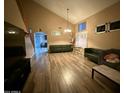 Spacious living room with vaulted ceilings, wood-look floors, and two sofas at 4112 S 249Th Dr, Buckeye, AZ 85326