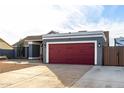 Gray house with red garage door and desert landscaping at 6931 W Cinnabar Ave, Peoria, AZ 85345