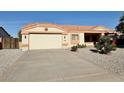 House exterior showcasing a two-car garage and neatly landscaped front yard at 11100 W Magdalena Dr, Arizona City, AZ 85123