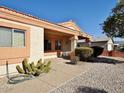 View of the home's side entrance with covered patio and cacti at 11100 W Magdalena Dr, Arizona City, AZ 85123