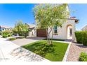 Two-story house with brown garage door and manicured lawn at 12045 W Peak View Rd, Peoria, AZ 85383