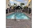 Community pool with brick patio and covered seating area at 1406 W Main St # 140, Mesa, AZ 85201
