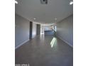 Open living room with tile floors and access to kitchen at 15494 S Kline Pl, Arizona City, AZ 85123