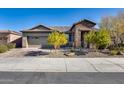 Single-story home with stone accents and landscaped front yard at 16731 S 181St Ave, Goodyear, AZ 85338
