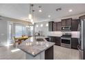 Modern kitchen with granite counters and stainless steel appliances at 16731 S 181St Ave, Goodyear, AZ 85338