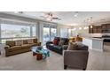 Open living room with tile floors and access to backyard at 16731 S 181St Ave, Goodyear, AZ 85338