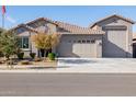 Two-story house with a three-car garage and desert landscaping at 24274 N 170Th Ln, Surprise, AZ 85387