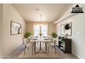 Bright dining room features a table with six chairs and decorative wall art at 3301 S Goldfield Rd # 2015, Apache Junction, AZ 85119