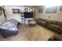 Living room featuring hardwood floors and a large TV at 3818 W Rose Ln, Phoenix, AZ 85019