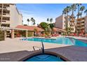 Inviting community pool and spa area with lounge chairs and a pergola at 4200 N Miller Rd # 408, Scottsdale, AZ 85251