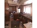 A cluttered kitchen with wooden cabinets and appliances at 5431 W Cholla St, Glendale, AZ 85304