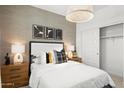 Cozy bedroom featuring a queen bed, wood nightstands, and contemporary wall decor at 7431 W Whitehorn Trl, Peoria, AZ 85383