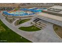 Aerial view of a community recreation center with pool, water park, and large building at 17872 W Getty Dr, Goodyear, AZ 85338