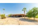 Single story home with covered carport and desert landscaping at 20165 W Moccasin Trl, Buckeye, AZ 85326