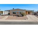 Cute single-wide mobile home with carport and desert landscaping at 2261 N Demaret Dr, Mesa, AZ 85215