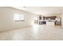 Open concept living room and kitchen with tile floors at 24387 W Flores Dr, Buckeye, AZ 85326