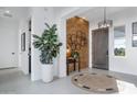 Bright and airy entryway with a wood accent wall and stylish decor at 17236 W Roseville St, Surprise, AZ 85388