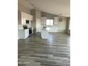 Modern kitchen featuring white cabinets, an island, and wood-look tile floors at 28109 N Faded Creek Rd, Florence, AZ 85132