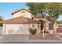 Two-story house with a beige exterior, attached garage, and landscaping at 4108 W Creedance Blvd, Glendale, AZ 85310