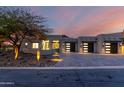 Modern house with three-car garage and desert landscaping at 11380 E Sand Hills Rd, Scottsdale, AZ 85255