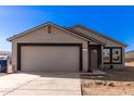 Newly built single-story home with a two-car garage and desert landscaping at 14126 S Diablo Rd, Arizona City, AZ 85123