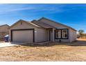 Newly built single-story home with a two-car garage and desert landscaping at 14126 S Diablo Rd, Arizona City, AZ 85123