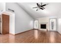 Spacious living room featuring hardwood floors and a fireplace at 17633 N Lindner Dr, Glendale, AZ 85308