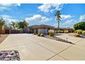 Home's exterior showcasing a long driveway and desert landscaping at 17931 W Oregon Ave, Litchfield Park, AZ 85340