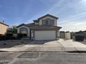 Two-story house with a large garage and well-maintained landscaping at 6891 W Via Del Sol Dr, Glendale, AZ 85310