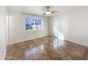 Simple bedroom with tile flooring and a large window at 724 N 66Th Pl, Mesa, AZ 85205