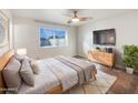 Cozy bedroom with wood-like flooring and plenty of natural light at 724 N 66Th Pl, Mesa, AZ 85205