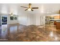 Bright and spacious living room with tile flooring and ceiling fans at 724 N 66Th Pl, Mesa, AZ 85205