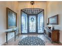 Elegant entryway with ornate iron door and decorative console tables at 10742 E Greythorn Dr, Scottsdale, AZ 85262