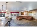 Open living room with a large sectional sofa and tile floors at 27041 N 31St Dr, Phoenix, AZ 85083