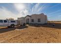 Newly constructed home with desert landscaping and driveway at 30500 N 208Th Dr, Wittmann, AZ 85361