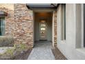Front entry with modern door and stonework detail at 16064 E Ridgestone Dr, Fountain Hills, AZ 85268