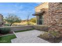 Backyard patio with artificial turf and desert landscaping at 16064 E Ridgestone Dr, Fountain Hills, AZ 85268