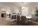Bright dining room with a white table, modern chairs, and large windows at 298 E Diamond Trl, San Tan Valley, AZ 85143